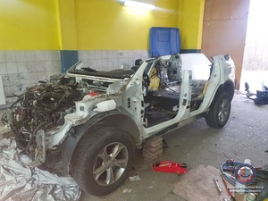 Biały, częściowo zdemontowany samochód marki Land Rover, odnaleziony przez policjantów w garażu jednej z posesji w gminie Dębe Wielkie.